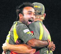 Amit Mishra celebrates his hattrick against Pune Warriors with Cameron White on Wednesday.  PTI
