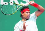 Rafael Nadal hits his trademark topspin forehand during his win.  Reuters