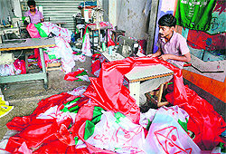 A worker prepares campaign flags for the Muttahida Qaumi Movement in Karachi on Wednesday