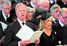 Margaret Thatcher's son Mark Thatcher and his wife Sarah sing a hymn during the funeral service, which was also attended by Queen Elizabeth and Prince Phillip