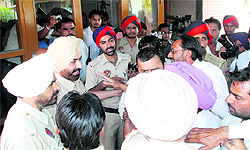 Station House Officer Jaspal Singh tries to pacify the irate family members of a woman who died a day after delivering a baby at Dr Mela Ram Hospital in Bathinda on Thursday