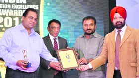 The management of the Quest Group of Institutions receive an award in Delhi.