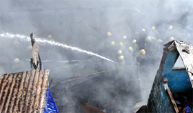 Firefighters try to douse the flame in a building at Teliwara Chowk, Sadar Bazar in Old Delhi on Thursday.