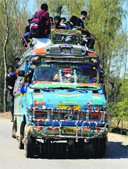 Schoolchildren atop an overloaded bus in south Kashmirs Anantnag district. 
