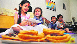 Girls sit during a 'kanjak pooja' on 'ashtami' in Ludhiana on Thursday.