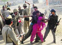 Policemen clash with protesters following a demonstration over the alleged rape and murder of a six-year-old girl in Aligarh on Thursday.  PTI