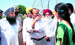 Divisional Commissioner SR Ladhar (centre) visits the marriage palace where a girl was thrashed by policemen in Tarn Taran, on Thursday