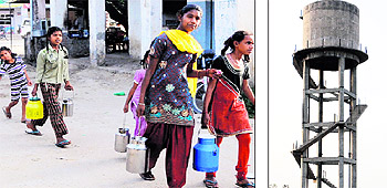 Children carry water at Baserke Hundal village, near Bhikhiwind, and (right) an overhead water tank that seldom supplies water to residents of Wan Tara Singh
