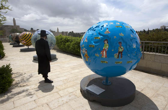 An Orthodox Jewish man stands next to giant globes displayed outside the walls of Jerusalems Old City on Wednesday.