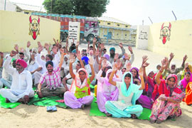 Residents holding a dharna in protest against construction of a godown at Mehta village on Friday. 