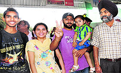 Simranjeet Singh and his family members wait for the Chandigarh-Amritsar Superfast Express at the railway station; and (below) Sandeep Kumar, along with his daughters, on board the train in Chandigarh on Friday