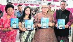 Governor Aziz Qureshi releases a souvenir of the Gorkhali Sudhar Sabha on its 75th anniversary in Dehradun on Friday. 