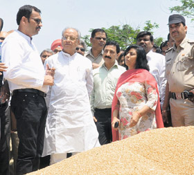 Haryana Food and Supply Minister Mahender Pratap Singh (2nd from left) takes stock of wheat arrival at the Karnal grain market on Friday.