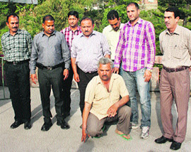 Dharampal in custody of Vigilance officials in Dharamsala on Friday.