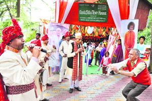 Artistes from Meerut play traditional music instruments as they welcome a religious procession at the railway station in Shimla on Friday.