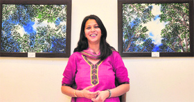 Navpreet Grewal Dhillon with her paintings at Gallery Atmosphere in Ludhiana.