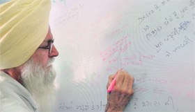A visitor writes a message at Kavita Mela organised at Punjabi Bhawan.