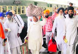 Pilgrims at the Attari railway station after returning from Pakistan on Friday. A Tribune photo