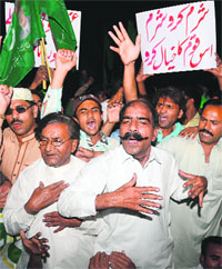 Supporters of former Pakistani president Pervez Musharraf shout slogans during a protest in Lahore on Thursday.