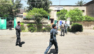 Policemen stand guard at a polling centre in Baghdad on Friday. 