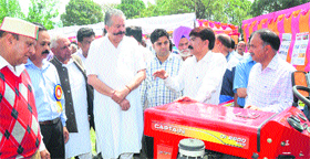 Agriculture Minister Sujan Singh Pathania interacts with the farmers at an exhibition in Palampur on Saturday.