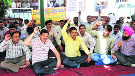 Members of the All J&K Patwar Association hold protest in Jammu on Saturday.