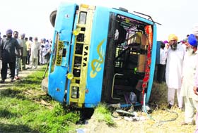 The mini-bus that overturned near Jagraon on Saturday