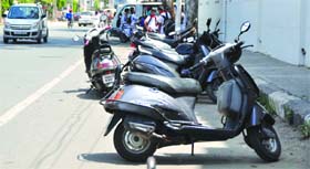 Two-wheelers parked outside a school in Shastri Nagar