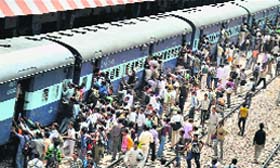 Aspirants clamber on to a passenger train after participating in an Army recruitment rally in Mathura on Saturday