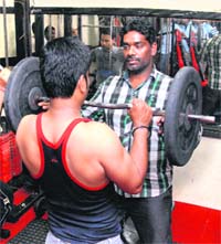 Murugan with a former addict and member of his gymnasium in Santoshi Nagar, Jalandhar. Tribune photo: Malkiat Singh 