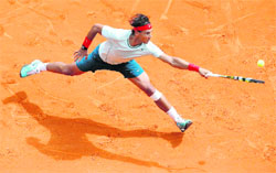 Rafael Nadal of Spain hits a return to Jo-Wilfried Tsonga of France during their men's singles semi-final tennis match of the Monte Carlo Masters in Monaco. 