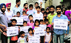 Volunteers with children belonging to economically weaker section at Sector 25 in Chandigarh on Sunday