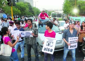 Activists of student unions block the road at ITO near the police headquarters during a demonstration against the rape of a five-year-old girl, in New Delhi on Sunday