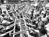 BJP's Mahila Morcha activists try to break barricades during a protest near UPA chief Sonia Gandhis residence over the rape of a minor girl in New Delhi on Sunday