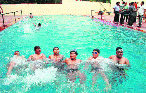Youths enjoy swimming during the inauguration of a swimming pool at the Gymkhana Club in Jalandhar on Sunday.