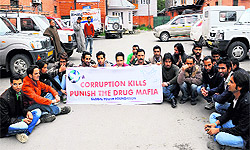 A group of activists of Global Yout Foundation hold stage a protest against spurious drug trade in Kashmir in Srinagar on Sunday