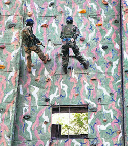 Indian and British Army personnel take part in a room intervention drill aimed to build and promote positive military relations between the countries by undertaking joint training for counter insurgency operations in Belgaum on Sunday.