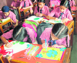 Students of Ryan International School take part in a poster-making activity on Earth Day in Amritsar on Monday