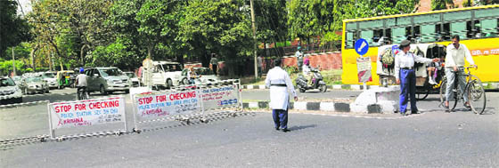 Despite the barricades put up due to one-way traffic, the policemen have to physically stop the vehicles from taking the wrong route.