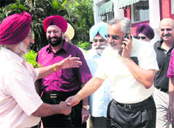 Gurinderjeet Sandhu (middle), re-elected president of the Chandigarh Golf Club, being congratulated by the members of the club on Monday. 