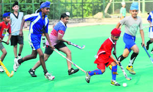 Students practise on AstroTurf at the Hockey Stadium, Sector 42, Chandigarh, on Monday. 