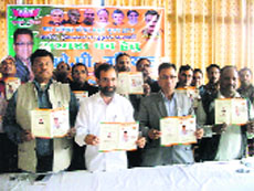BJP members release a manifesto for the civic bodies elections in Mussoorie on Monday.