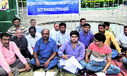 Members of the International Human Rights Organisation stage a dharna at Gandhi Park in Dehradun on Monday against the rape of a five-year-old girl in New Delhi