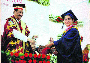  Dr Shalini Chaudhary receives the universitys topper certificate from the Maharastra Chief Minister, Prithvi Raj Chavan, during the convocation programme of DY Patil University at Kohlapur in Maharashtra. 