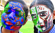 Students of GMT Public School carry messages on their painted faces on World Earth Day in Ludhiana on Monday