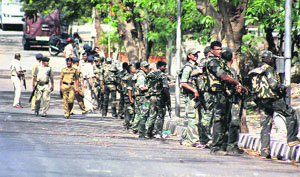 Police personnel conduct a combing operation in Mumbai on Monday after some suspected terrorists allegedly entered a deserted building in the wee hours.
