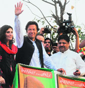 Imran Khan waves at a rally in Lahore. 