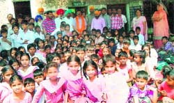 The school staff and local residents honour former Mayor Sunil Dutti for funding a water pump at the Government School, Maqboolpura, in Amritsar on Tuesday. A Tribune Photograph. 