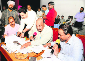 Successful bidders sign papers in Chandigarh on Tuesday
