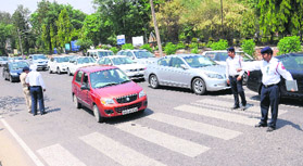 Policemen regulate traffic in front of schools at Sector 26 in Chandigarh on Tuesday.